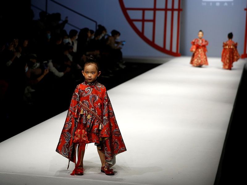 To many, they indicate a late-summer recovery in Chinese household spending is broadening and propelling the next stage of the economic recovery. Above, child models present creations from the MIBAI Spring/Summer 2021 collection show by Qingmei Lou, during China Fashion Week. Image Credit: REUTERS